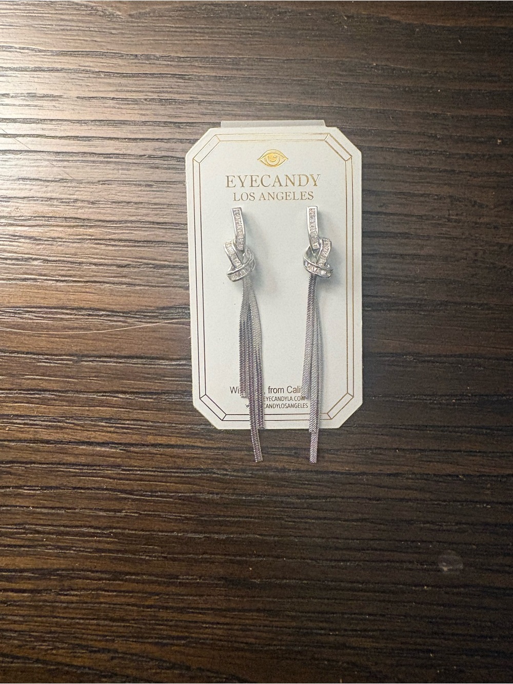 NEW Eye Candy silver knot dangle earrings.